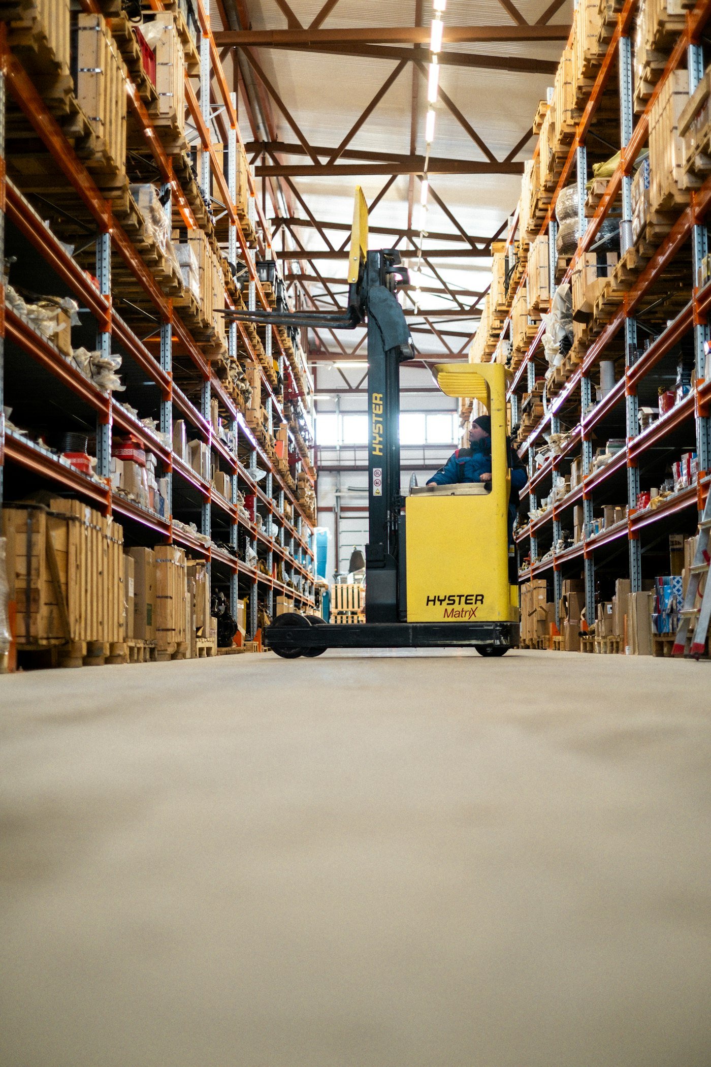Forklift moving pallets in a distribution warehouse
